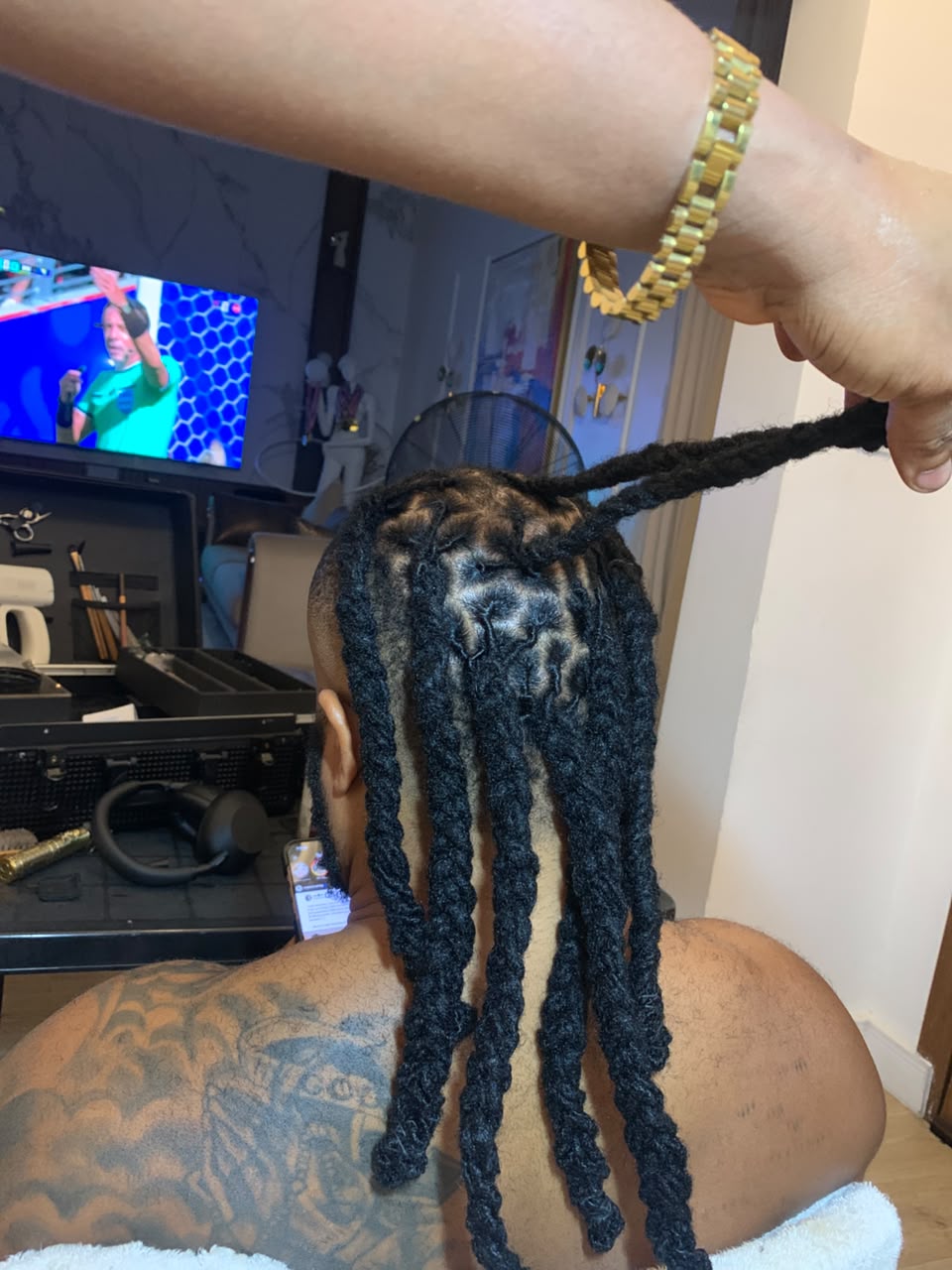 Back view of long sectioned braids being styled